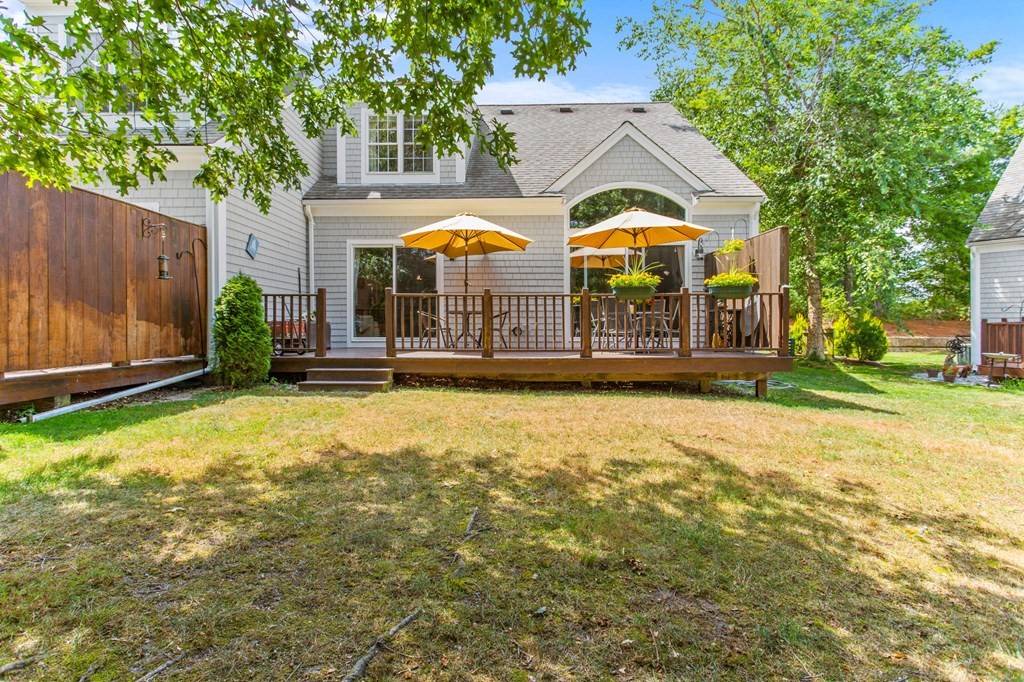 1 Prestwick Road, Unit 1 Bourne, MA 02532 - Photo 24 of 31 a view of a house with a yard and sitting area