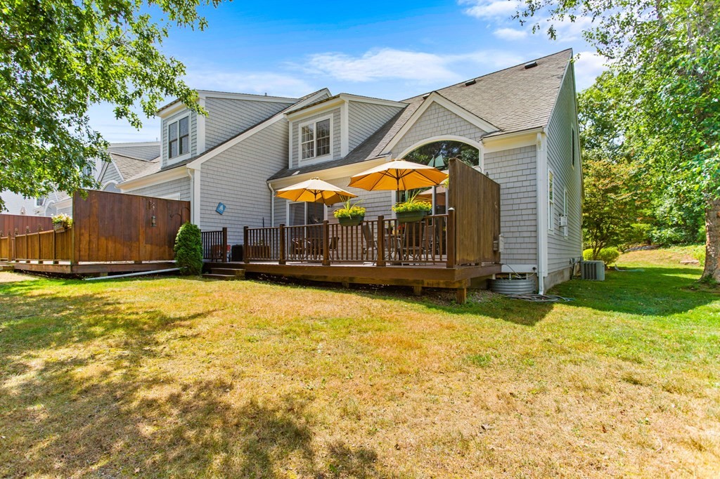 1 Prestwick Road, Unit 1 Bourne, MA 02532 - Photo 25 of 31 a view of a house with a yard