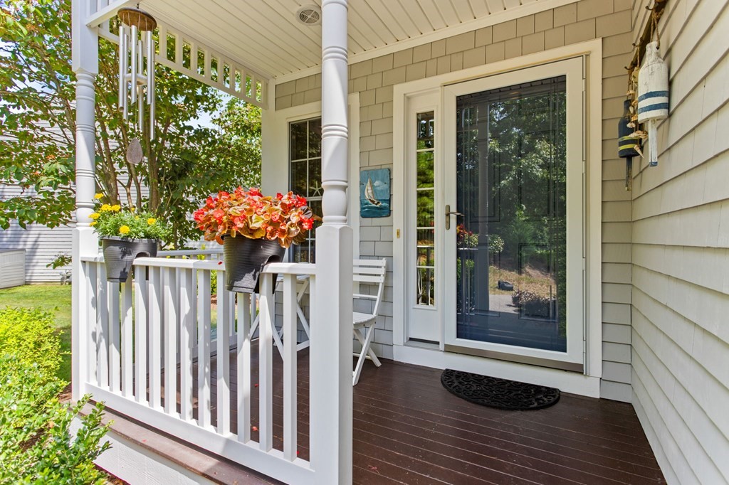 1 Prestwick Road, Unit 1 Bourne, MA 02532 - Photo 3 of 31 a front view of a house with a porch