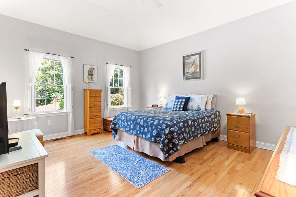 1 Prestwick Road, Unit 1 Bourne, MA 02532 - Photo 4 of 31 a bedroom with a bed and a window