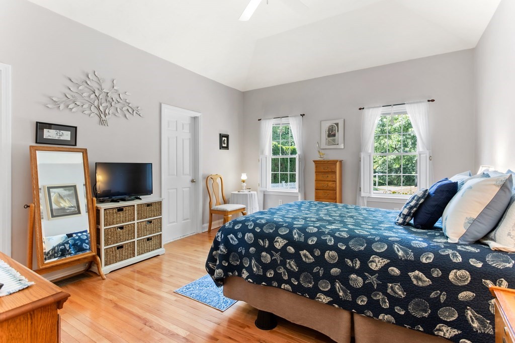 1 Prestwick Road, Unit 1 Bourne, MA 02532 - Photo 5 of 31 a bedroom with a bed and a flat screen tv