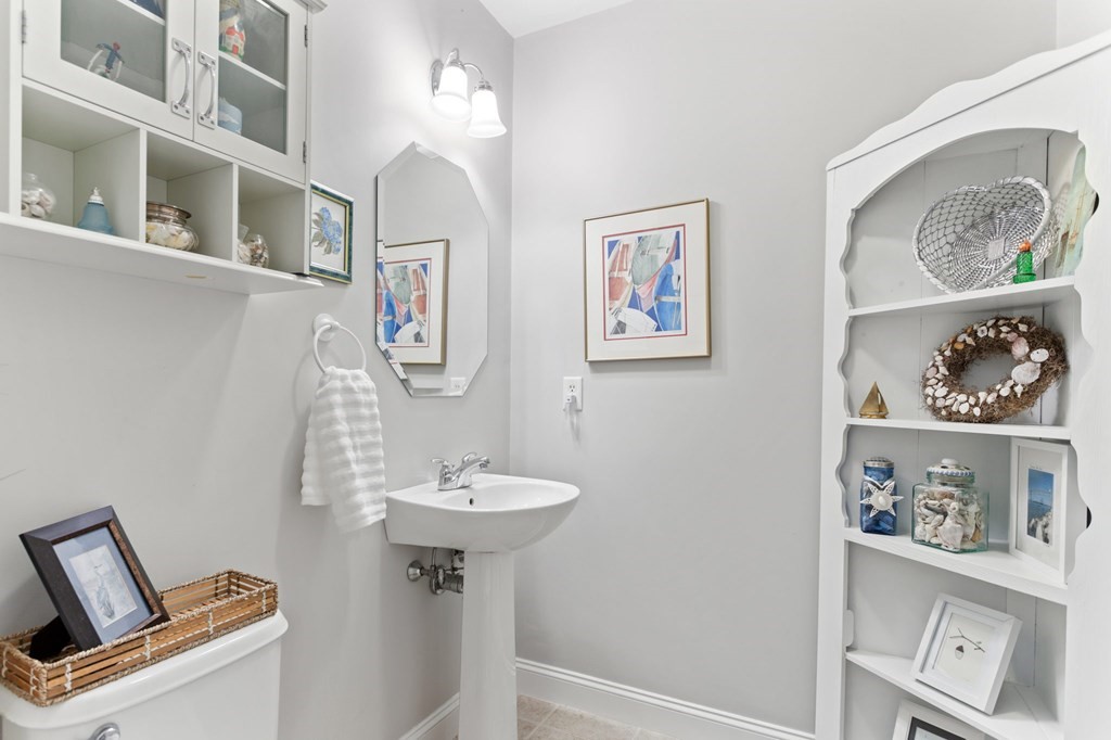 1 Prestwick Road, Unit 1 Bourne, MA 02532 - Photo 7 of 31 a bathroom with a sink and a mirror