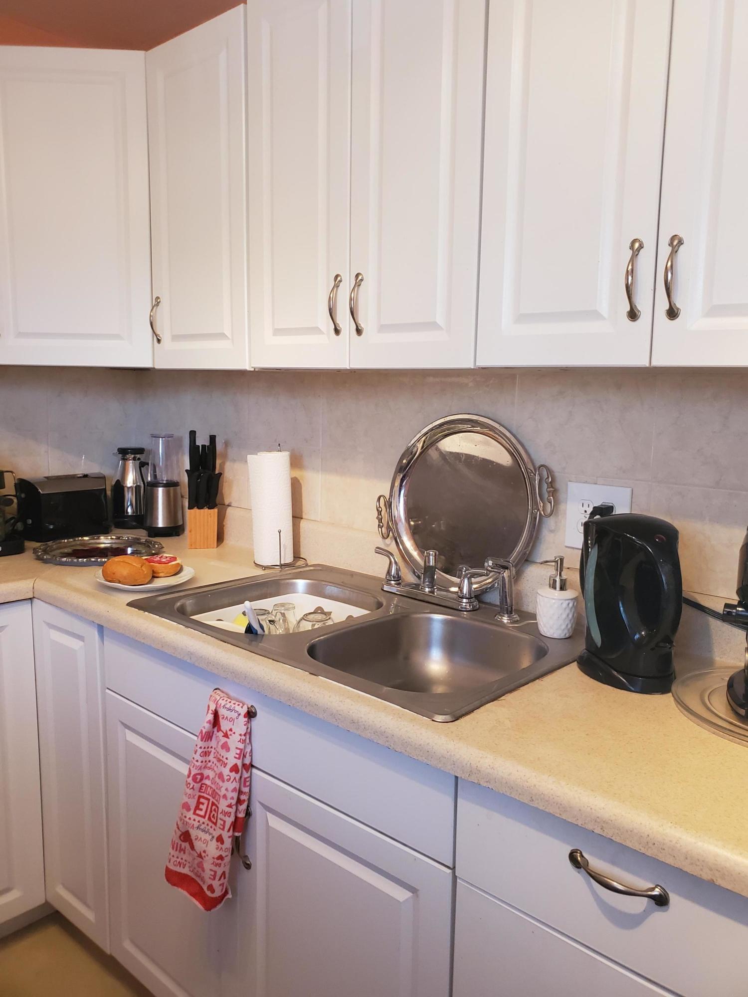 2400 Northeast 1st Lane, Unit 206 Boynton Beach, FL 33435 - Photo 12 of 32 a kitchen with a stove and cabinets