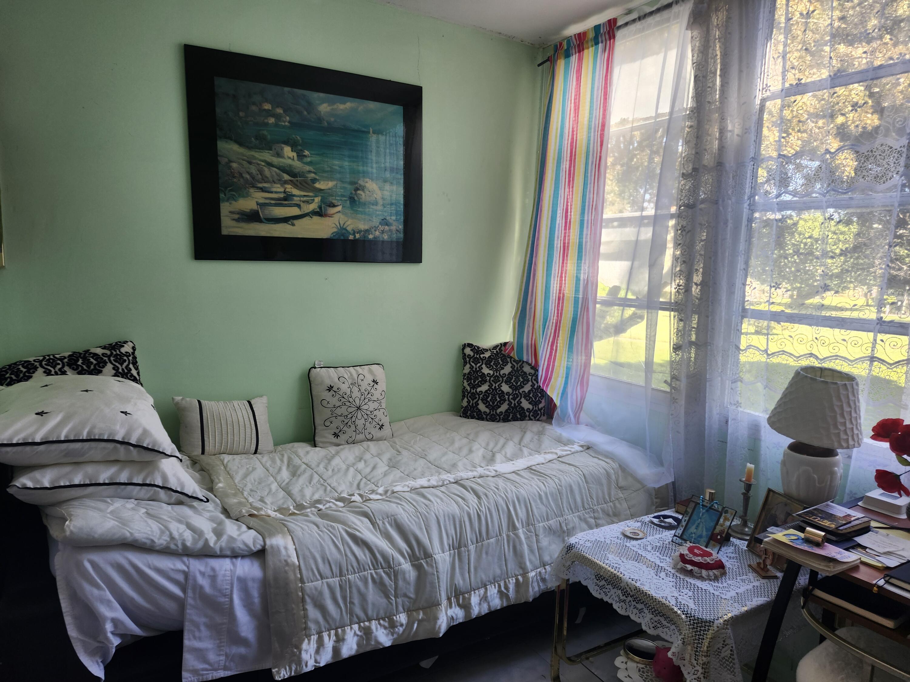 2400 Northeast 1st Lane, Unit 206 Boynton Beach, FL 33435 - Photo 14 of 32 a bedroom with a bed and wooden floor