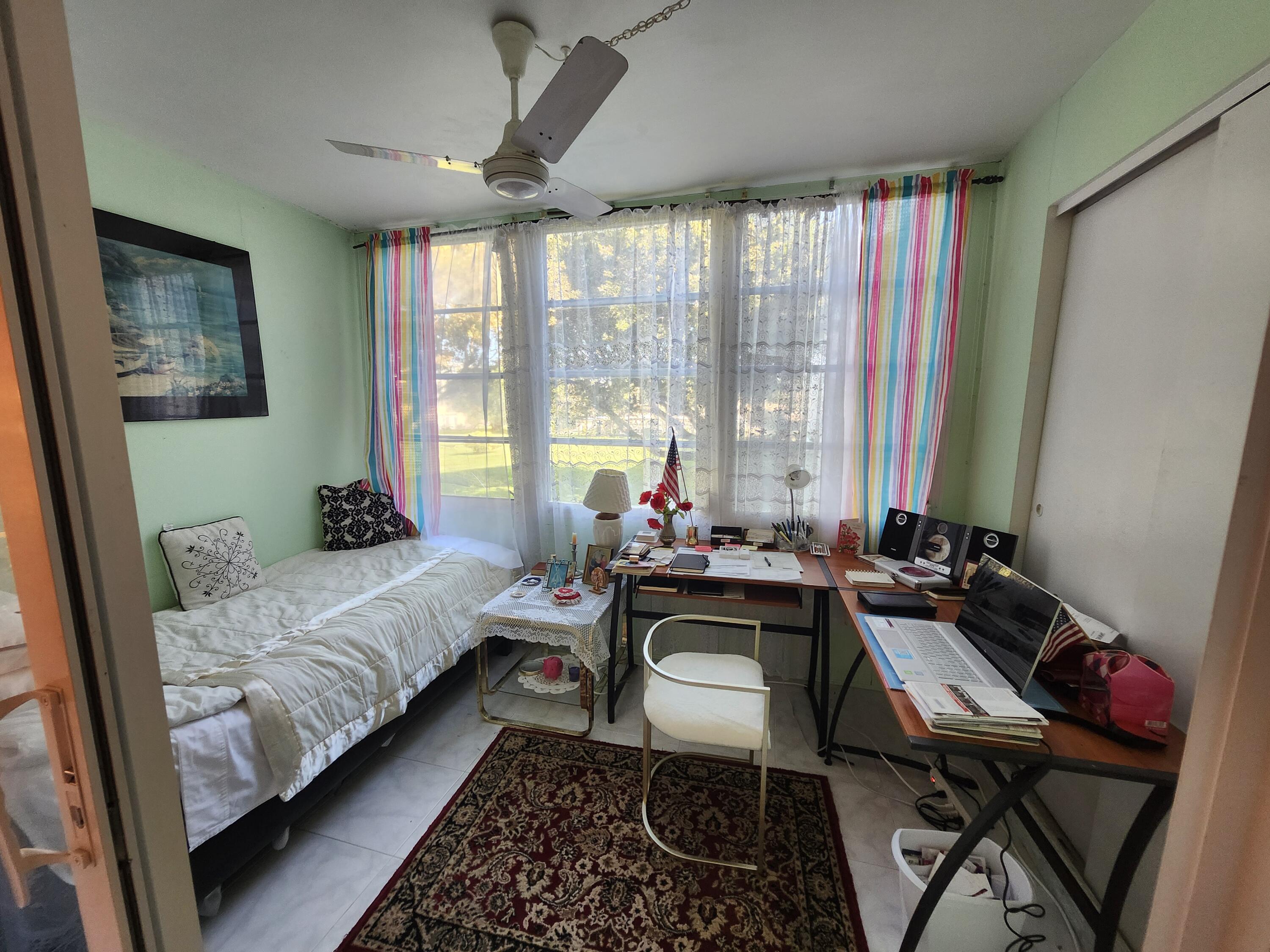 2400 Northeast 1st Lane, Unit 206 Boynton Beach, FL 33435 - Photo 15 of 32 a bed room with a bed and a window