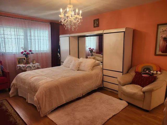 a bedroom with bed couch and window