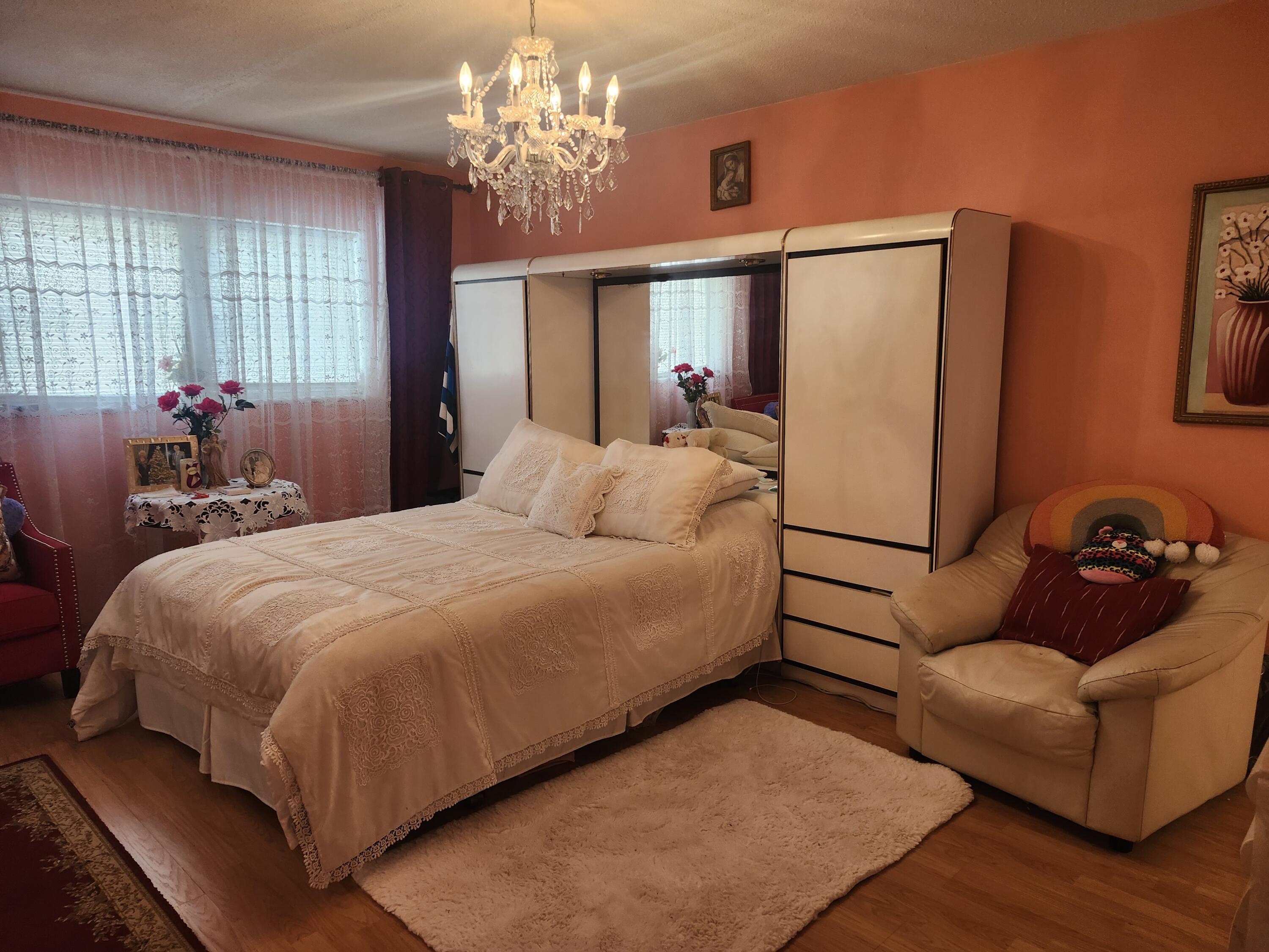 2400 Northeast 1st Lane, Unit 206 Boynton Beach, FL 33435 - Photo 2 of 32 a bedroom with bed couch and window