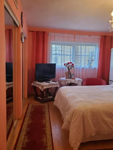 a bed sitting in a bedroom next to a window