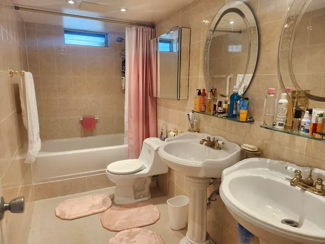 a bathroom with a toilet sink and mirror