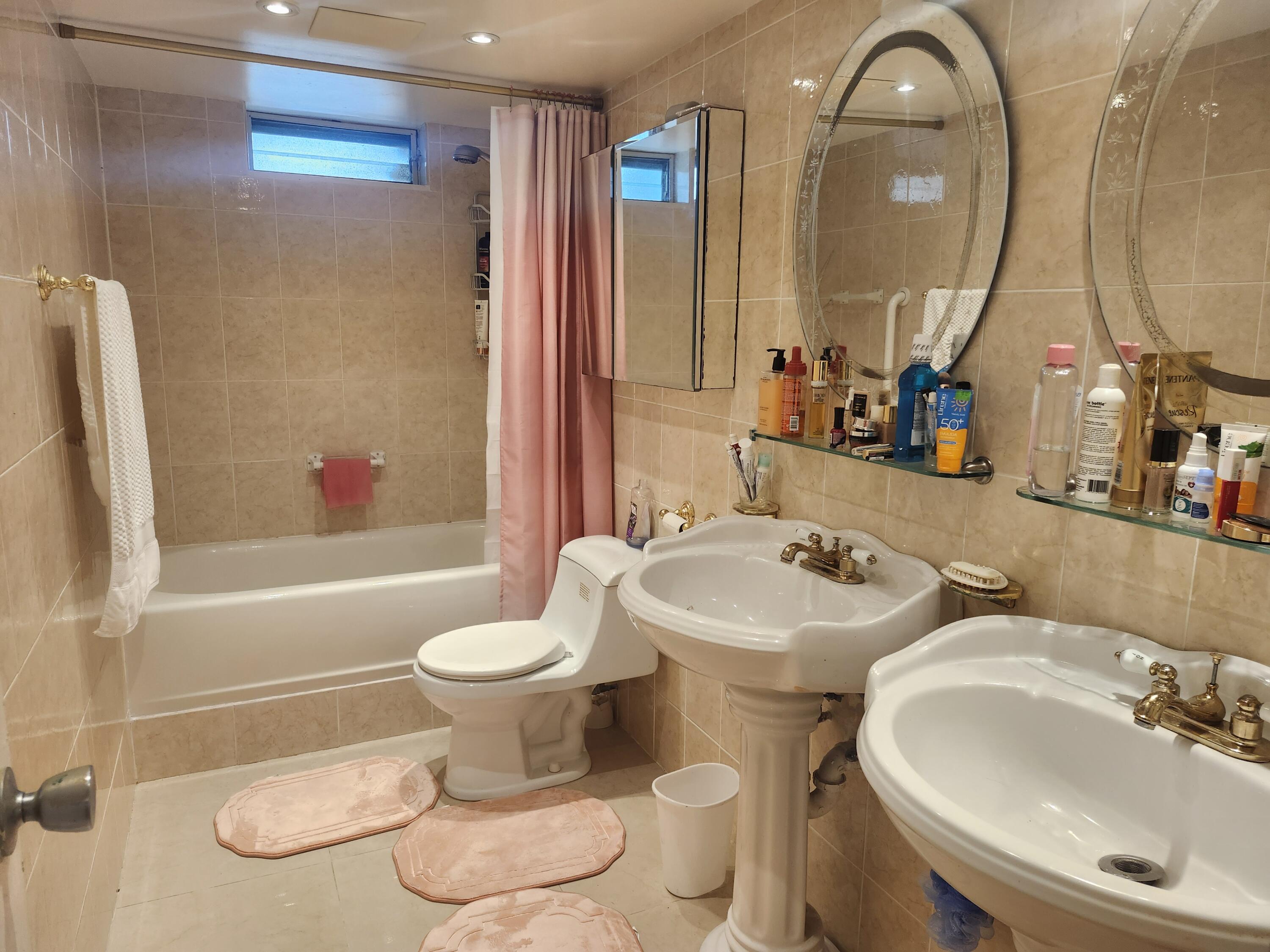 2400 Northeast 1st Lane, Unit 206 Boynton Beach, FL 33435 - Photo 6 of 32 a bathroom with a toilet sink and mirror