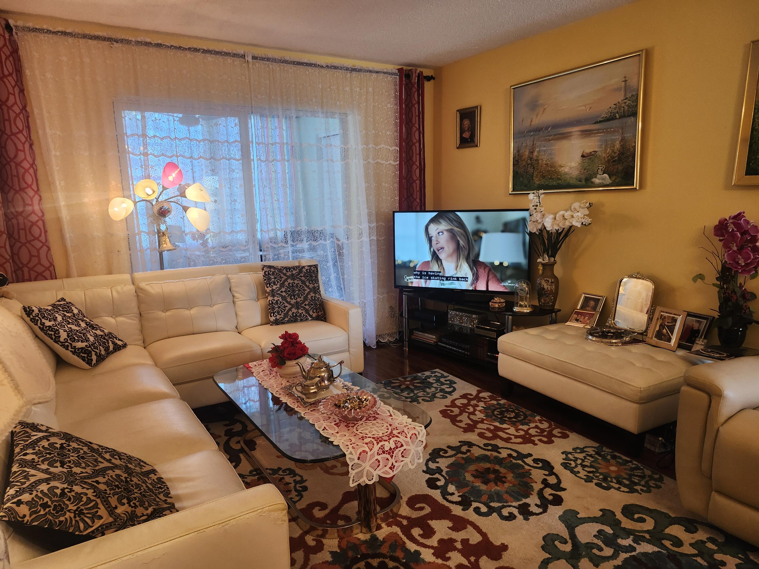2400 Northeast 1st Lane, Unit 206 Boynton Beach, FL 33435 - Photo 8 of 32 a living room with furniture and a flat screen tv