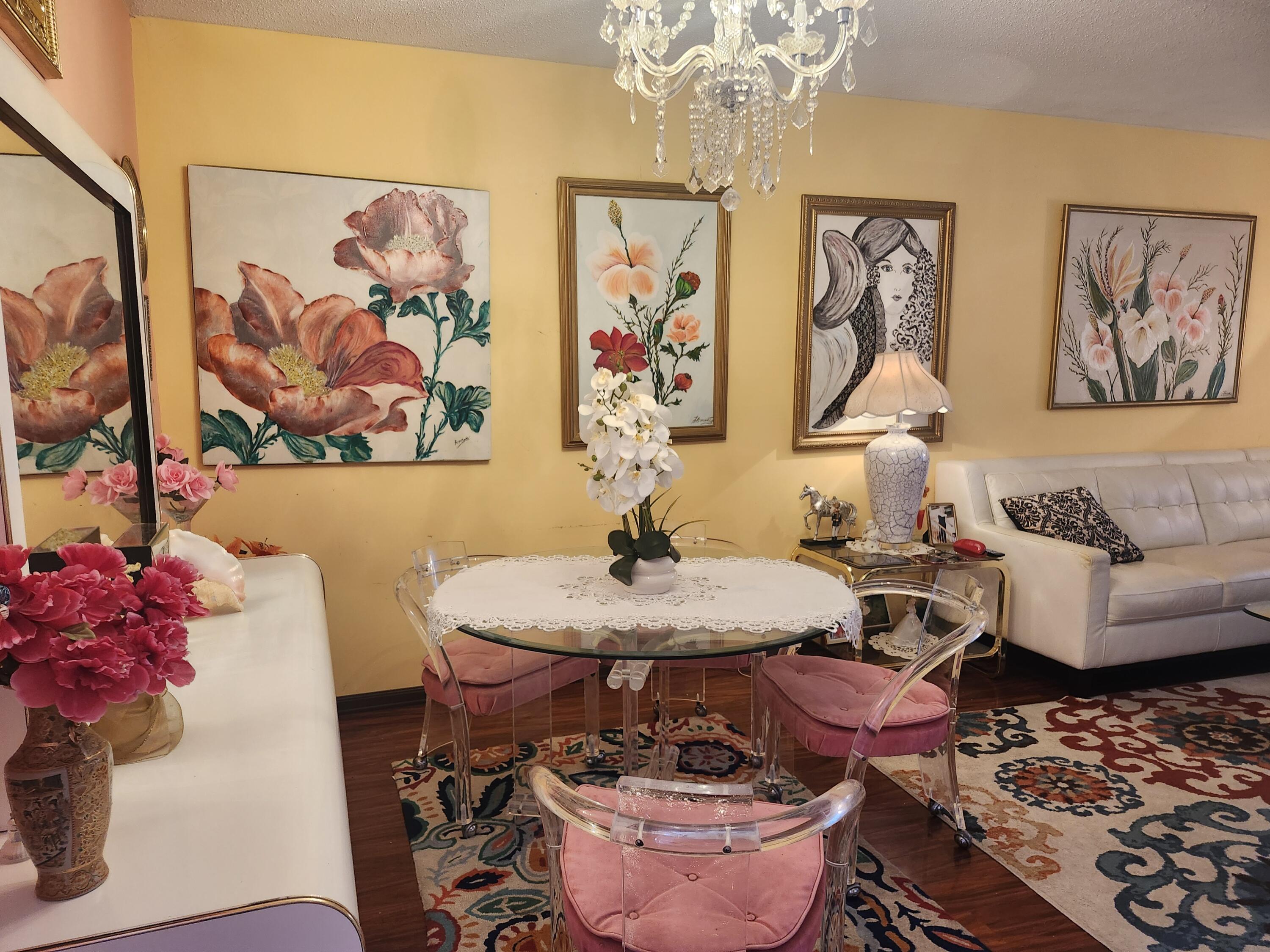 2400 Northeast 1st Lane, Unit 206 Boynton Beach, FL 33435 - Photo 10 of 32 a living room with furniture and a chandelier