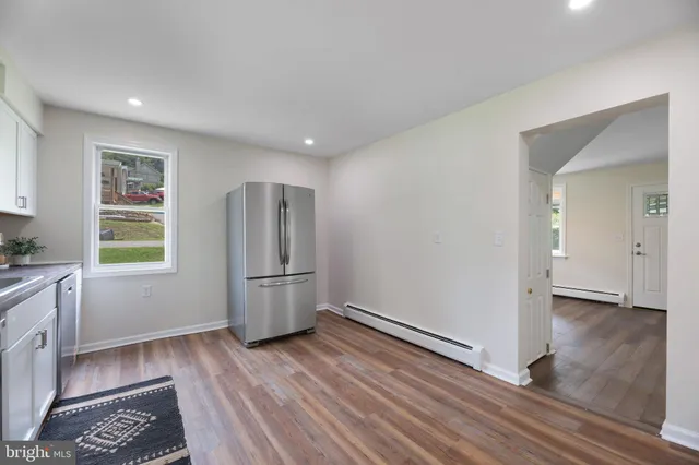 a view of kitchen with furniture and stainless steel appliances