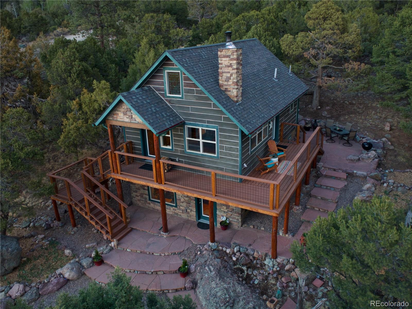 an aerial view of a house with a yard balcony