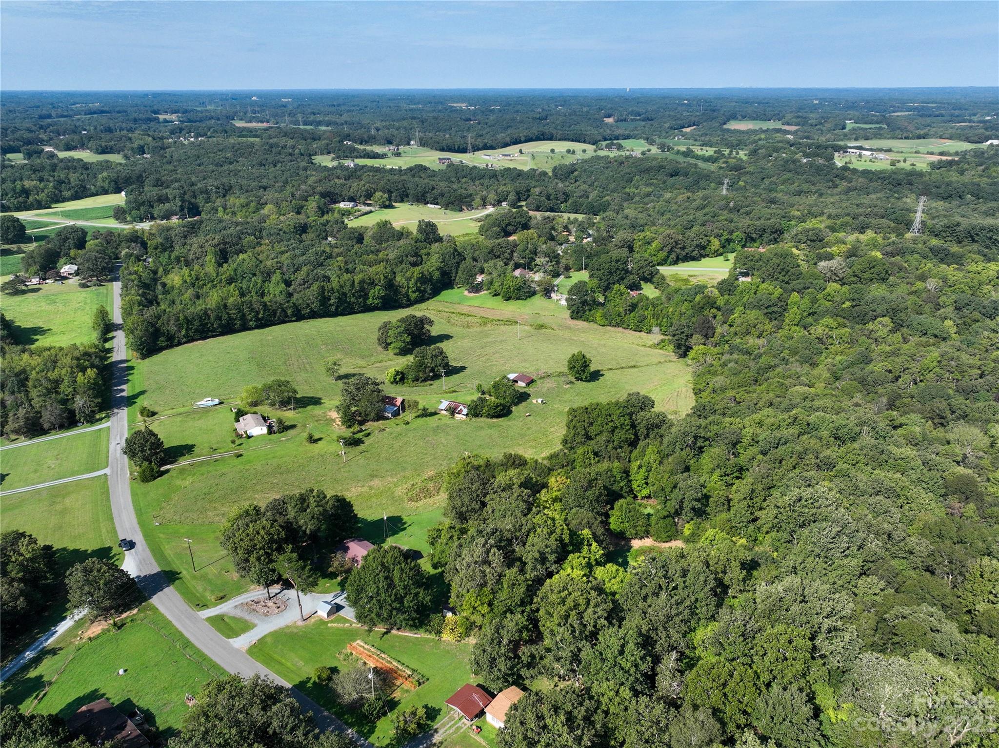 0 Santa Claus Road Monroe, NC 28110 - Photo 26 of 43 an aerial view of green landscape with trees houses and mountain view