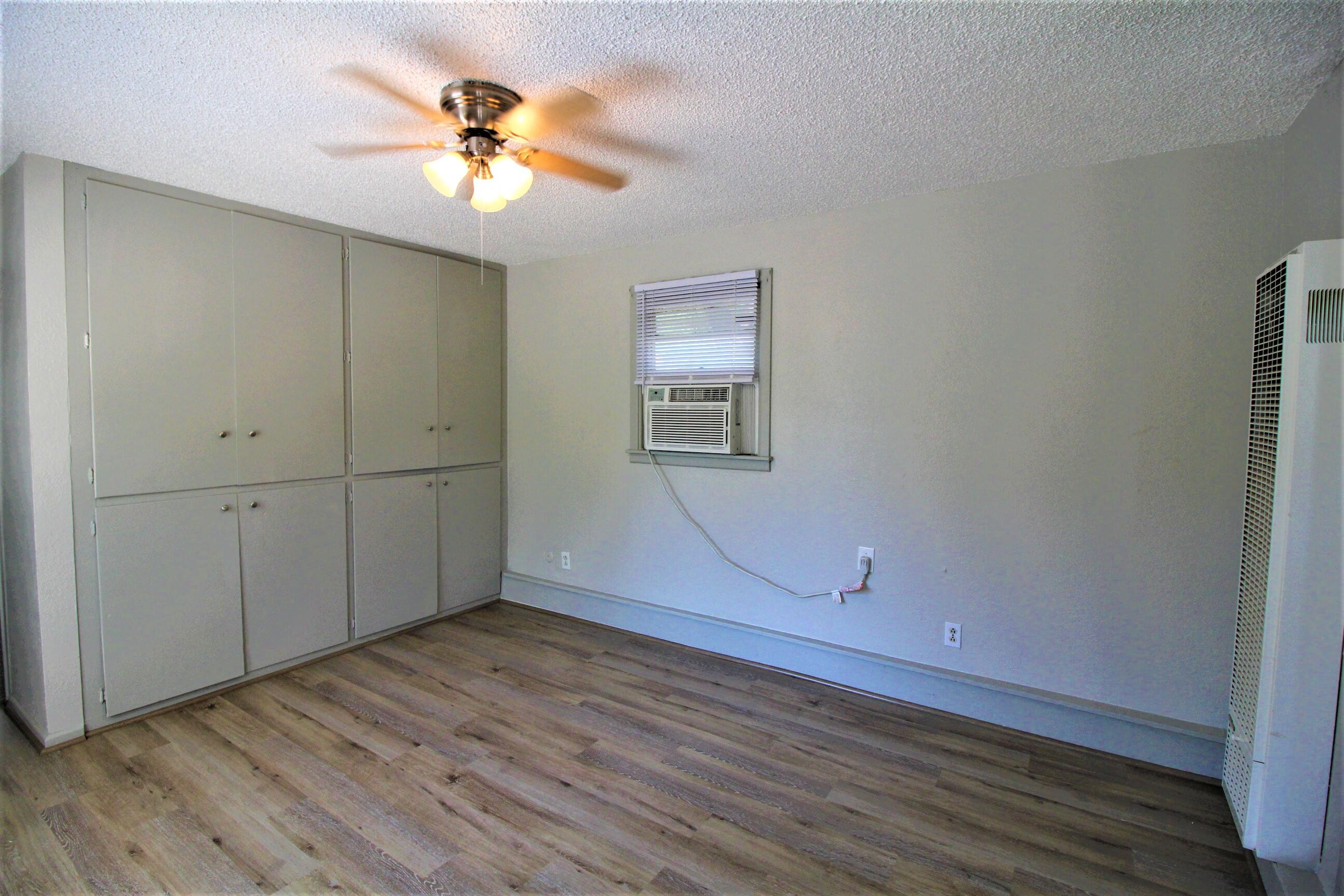 2216 30th Street Lubbock, TX 79411 - Photo 14 of 21 an empty room with wooden floor and a ceiling fan