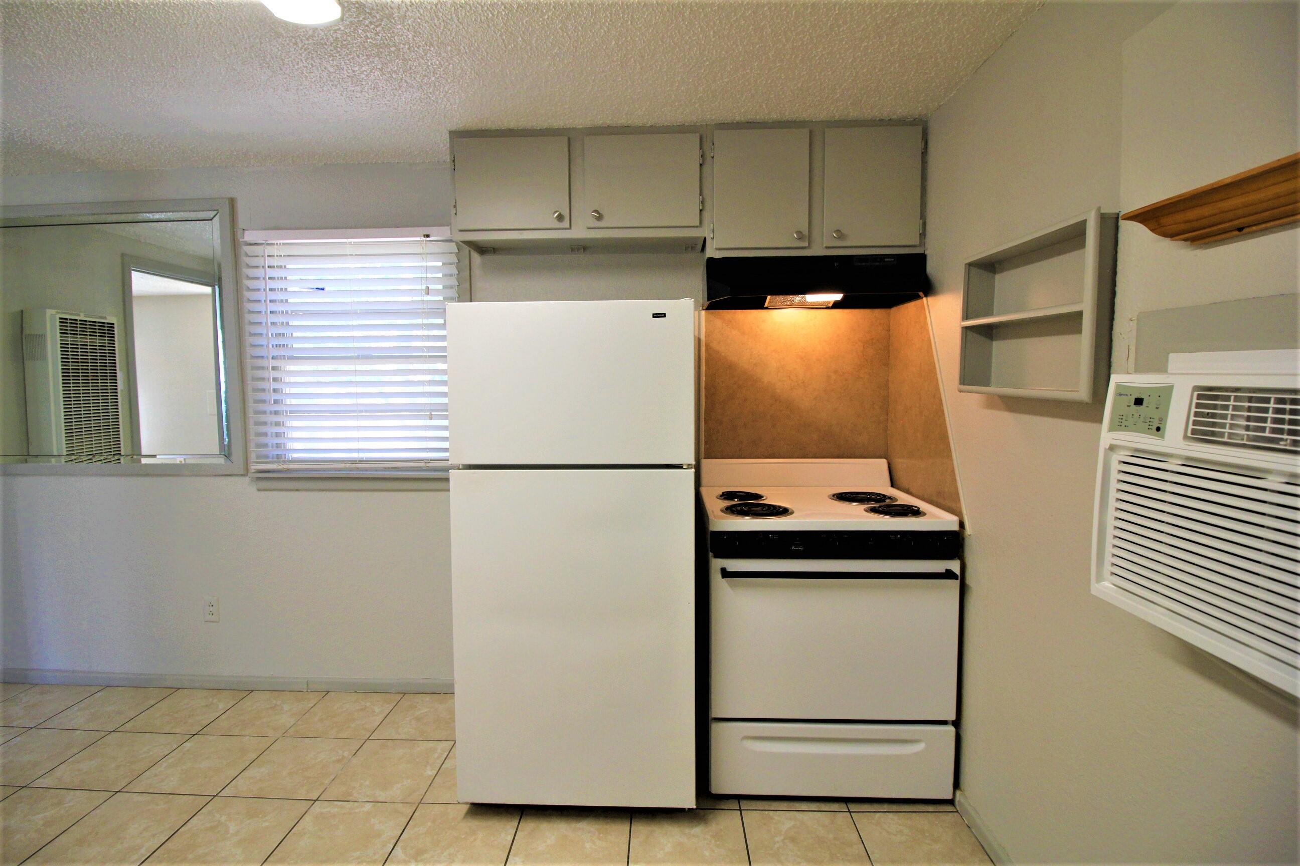 2216 30th Street Lubbock, TX 79411 - Photo 16 of 21 a kitchen with a refrigerator and a stove