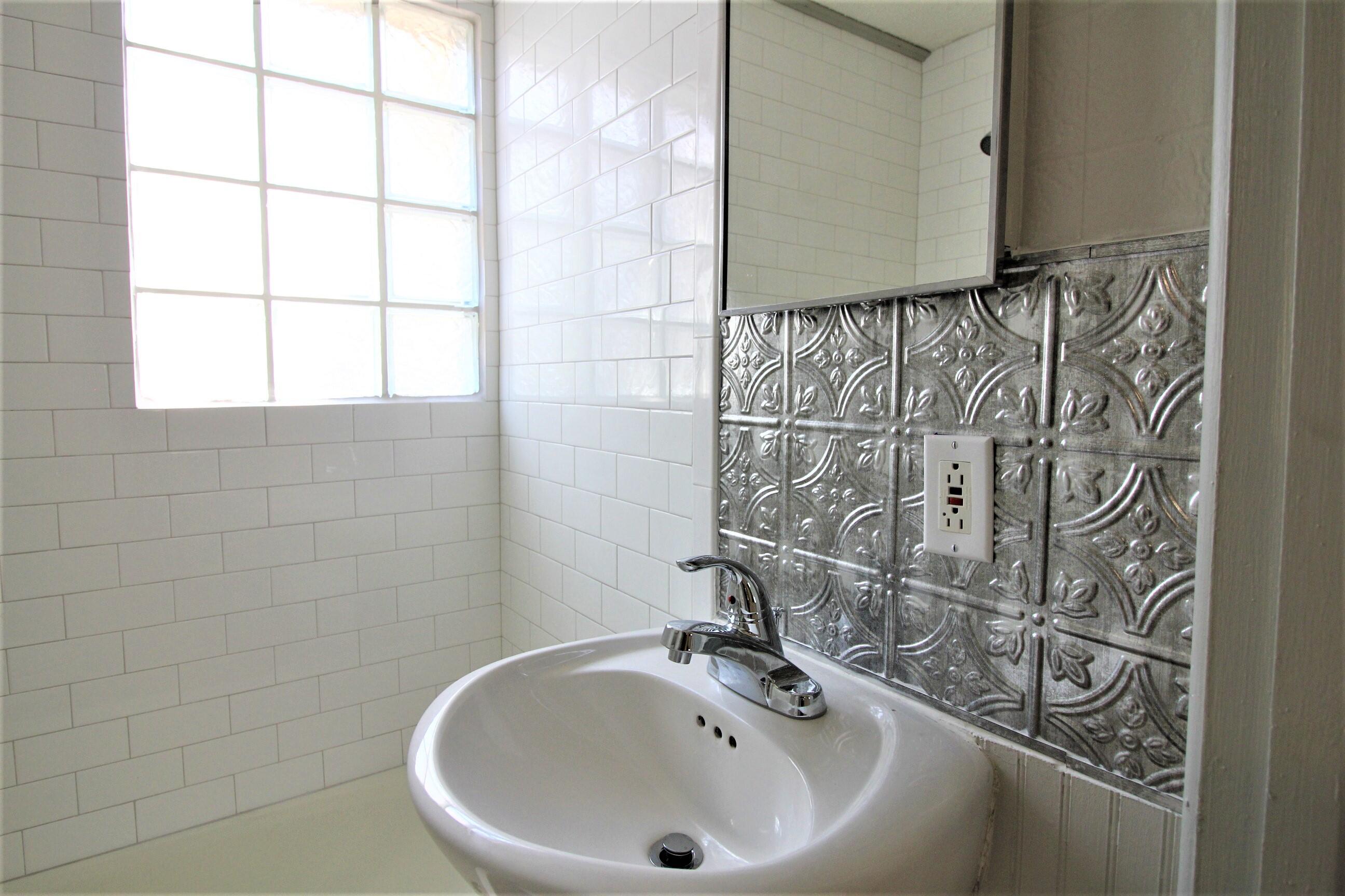 2216 30th Street Lubbock, TX 79411 - Photo 21 of 21 a bathroom with a sink and a mirror