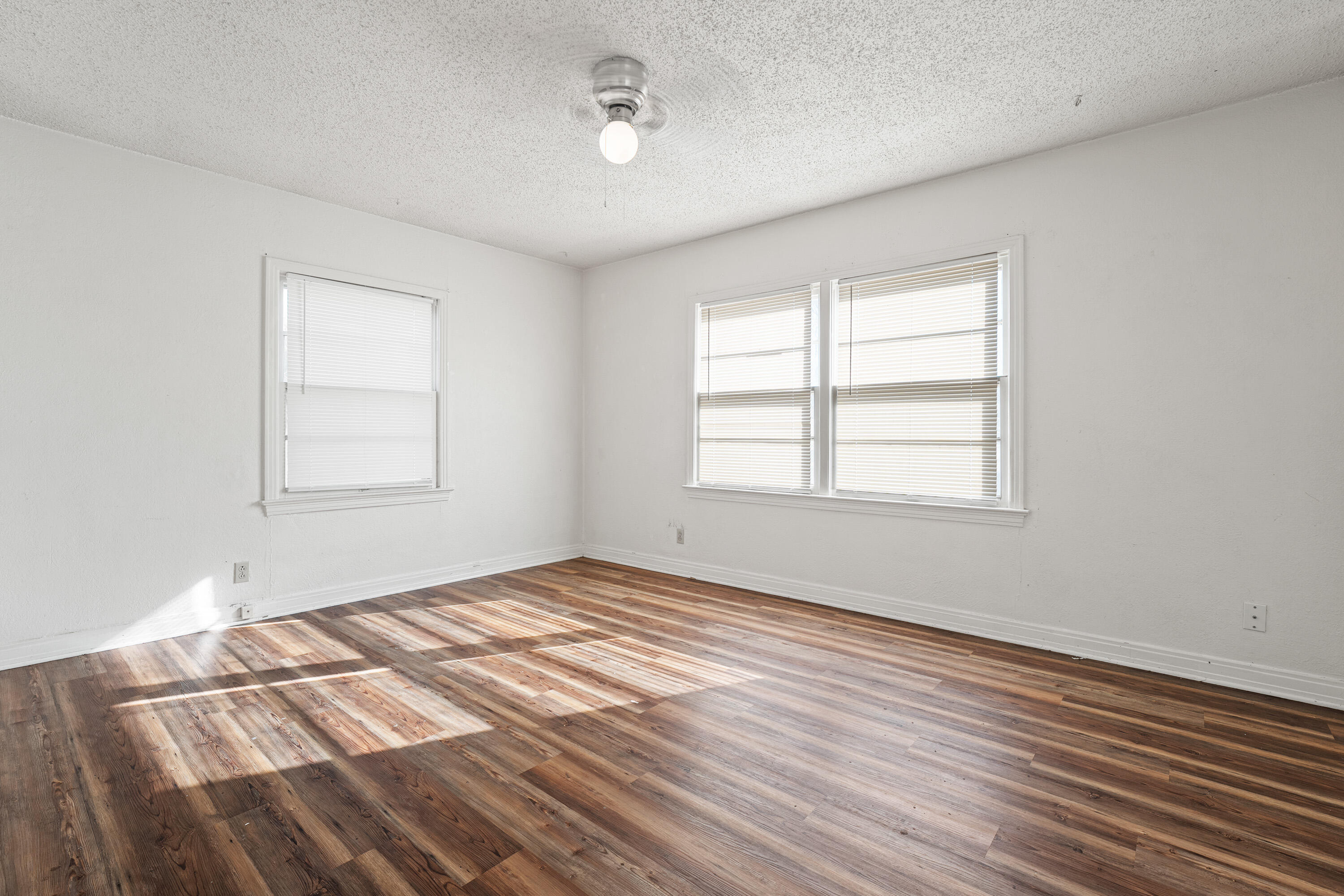 2216 30th Street Lubbock, TX 79411 - Photo 8 of 21 a view of empty room with wooden floor and fan