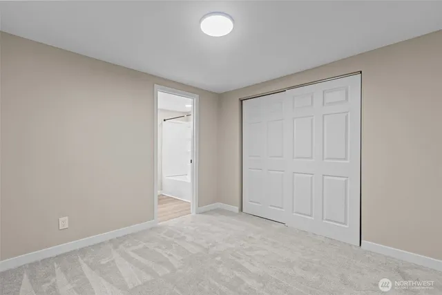 an empty room with closet area