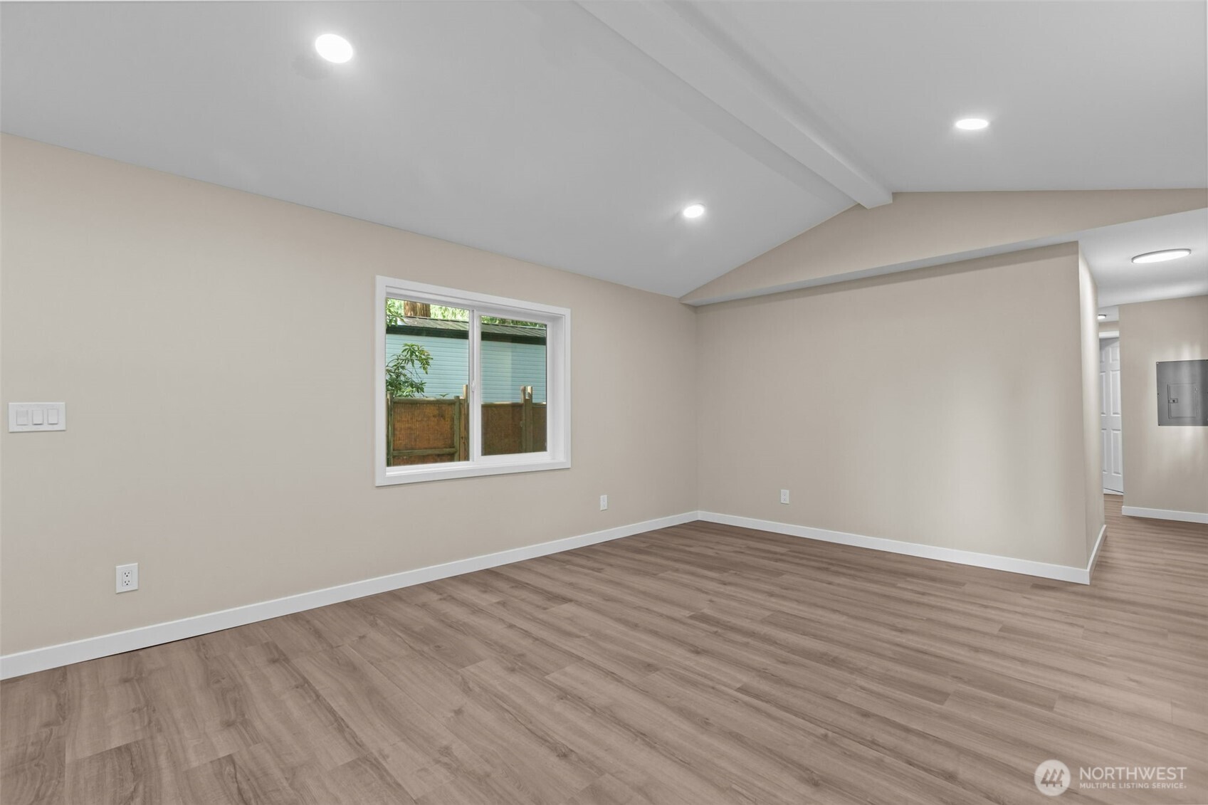 1729 194th Street Southeast, Unit 6 Bothell, WA 98012 - Photo 5 of 26 a view of an empty room with wooden floor and a window