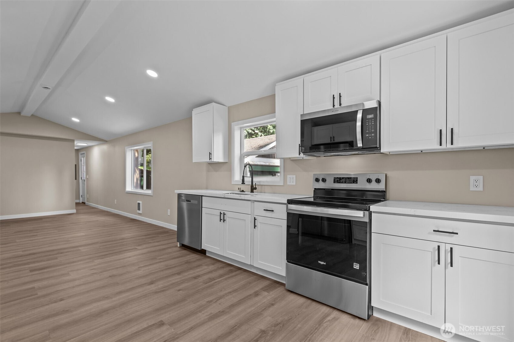 1729 194th Street Southeast, Unit 6 Bothell, WA 98012 - Photo 8 of 26 a kitchen with stainless steel appliances granite countertop a stove top oven a sink and white cabinets