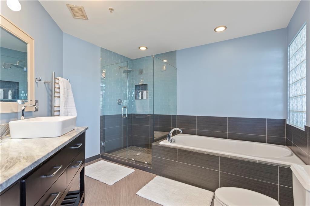 3180 Mathieson Drive Northeast, Unit 807 Atlanta, GA 30305 - Photo 13 of 22 a bathroom with a tub sink and mirror