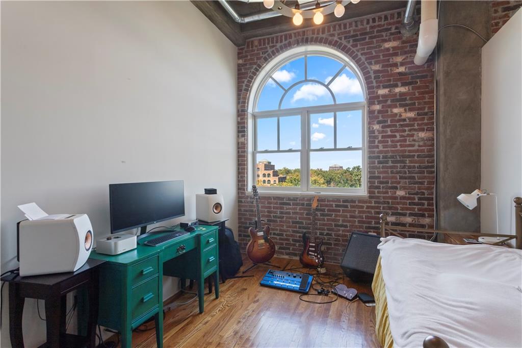 3180 Mathieson Drive Northeast, Unit 807 Atlanta, GA 30305 - Photo 15 of 22 a bedroom with a bed and a flat screen tv