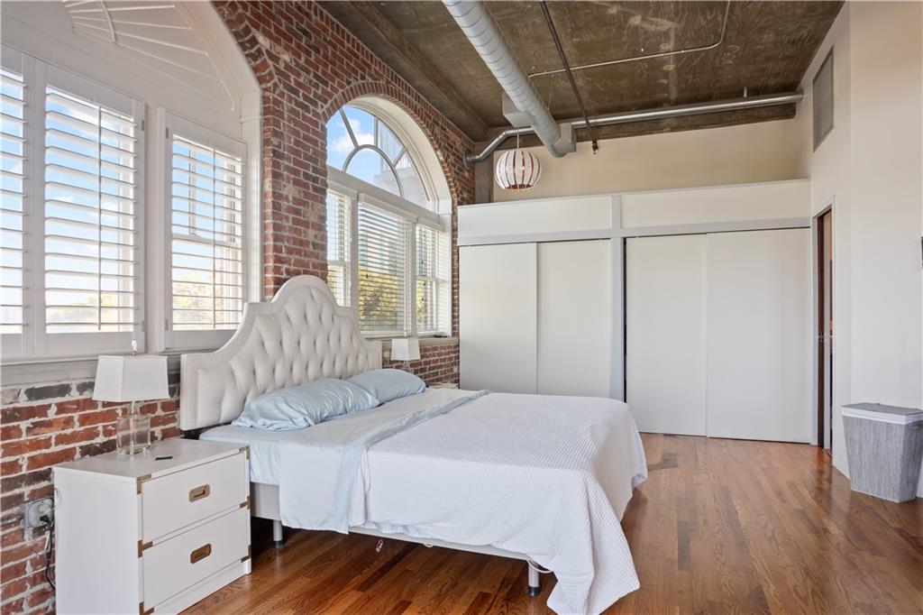 3180 Mathieson Drive Northeast, Unit 807 Atlanta, GA 30305 - Photo 10 of 22 a bedroom with a bed and a window