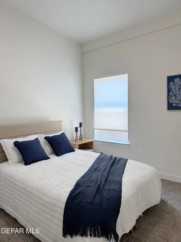 a bedroom with a bed and window