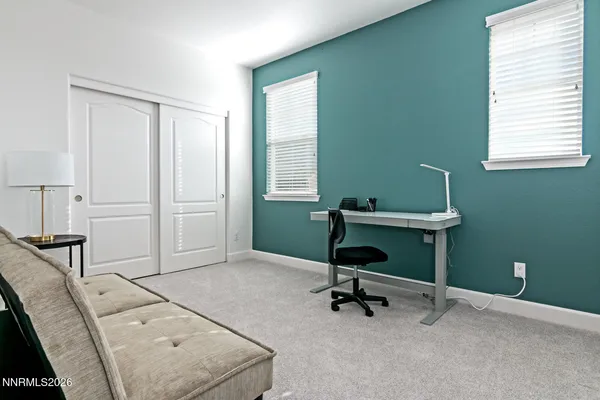 a view of a workspace with a window and chair