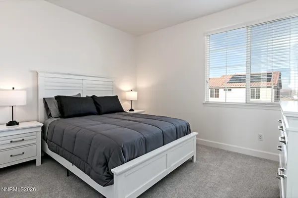 a bed sitting in a bedroom next to a window