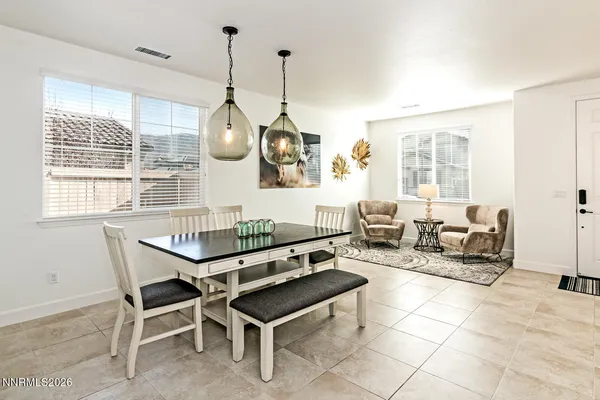a living room with furniture a table and chairs