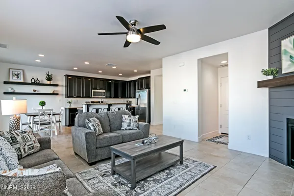a living room with furniture and kitchen view
