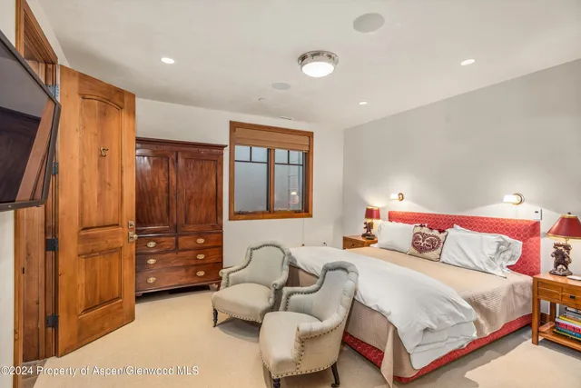 a bedroom with two beds and a couch