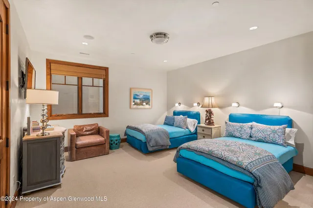 a room with furniture a rug and a chandelier