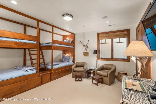a living room with furniture and a book shelf