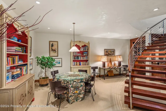 a room with furniture a flat screen tv and floor to ceiling window
