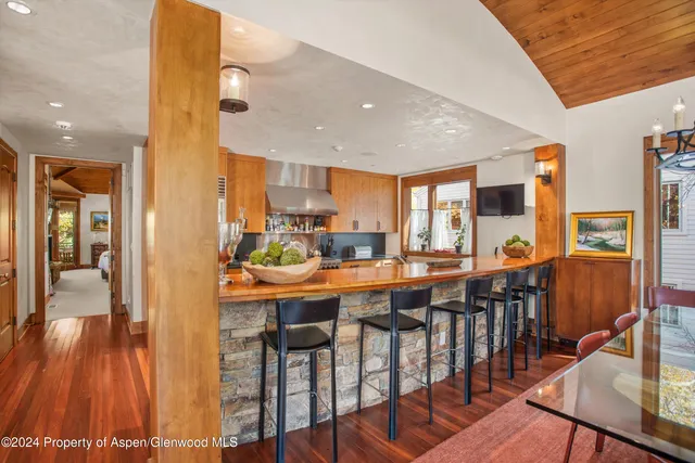 a bathroom with a granite countertop double vanity sink and a mirror