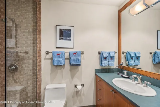 a dining room with wooden floor furniture and a chandelier