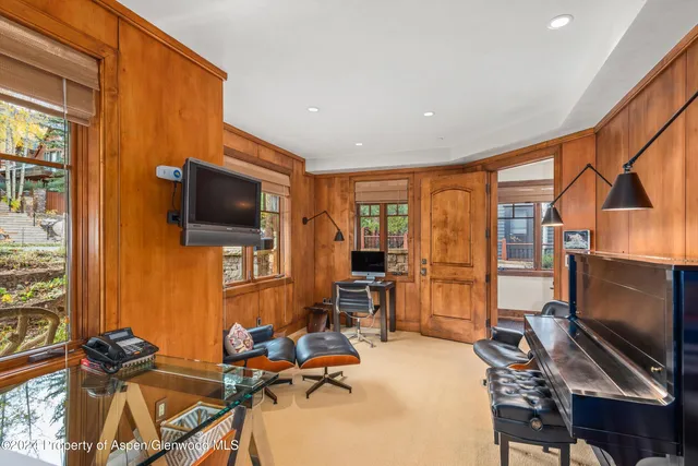 a bedroom with furniture and a large window