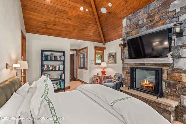 a living room with furniture and floor to ceiling windows