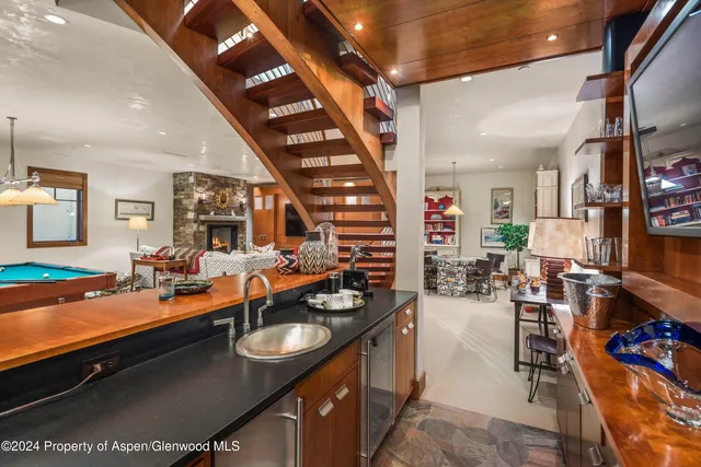a view of a patio with table and chairs with wooden floor and fence