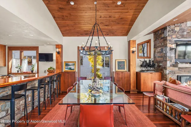 a front view of a house with a tree