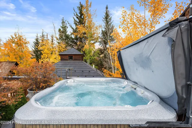 a spacious bedroom with a bed and wooden floor