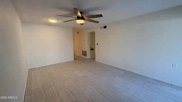 a view of an empty room with wooden floor
