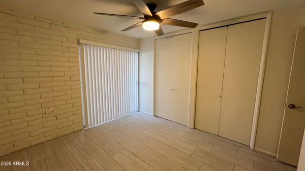 a view of empty room with ceiling fan