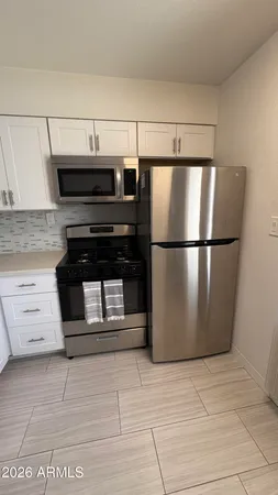 a kitchen with appliances and cabinets