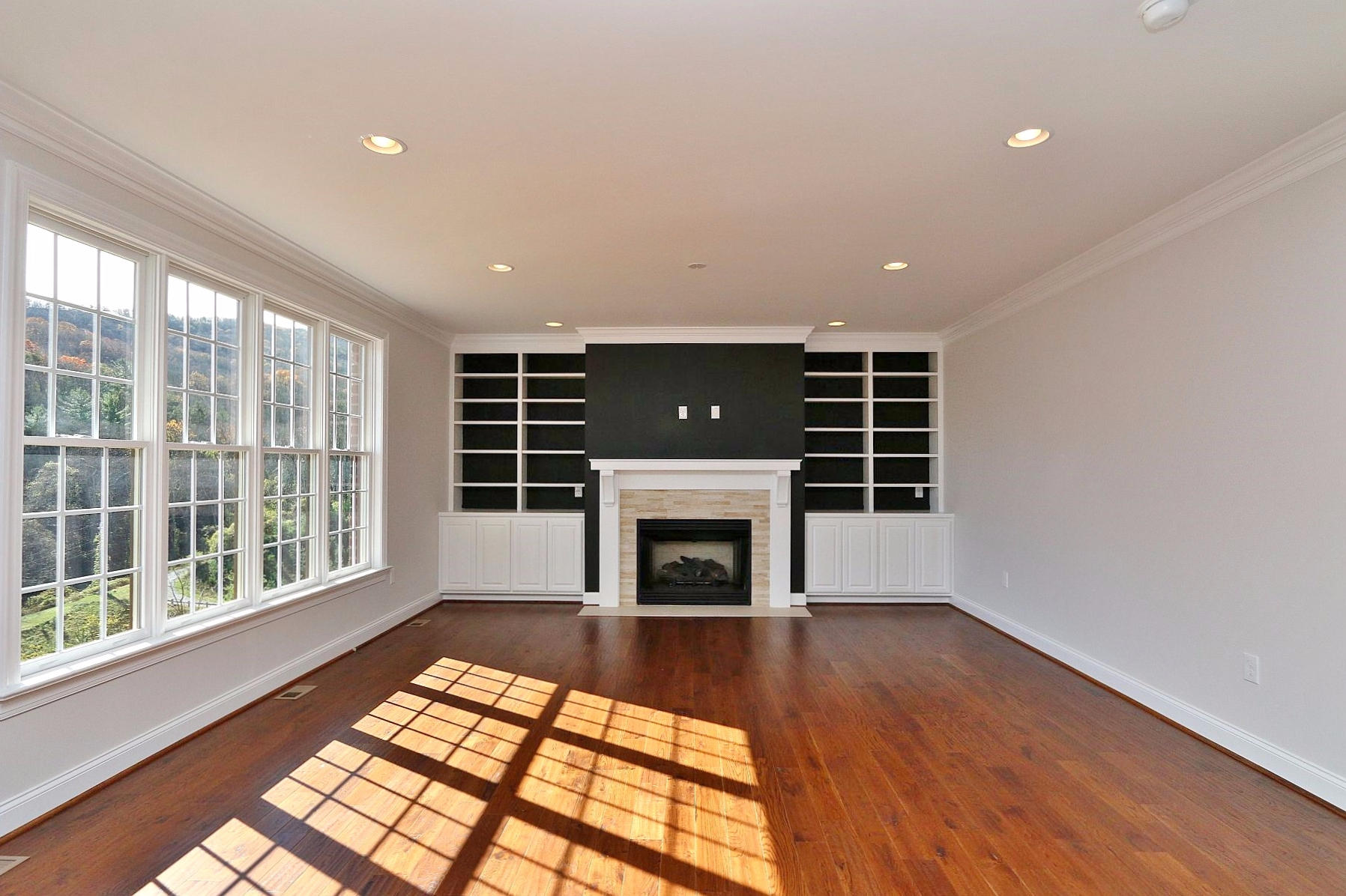 6875 Fairway Ridge Road Salem, VA 24153 - Photo 24 of 91 a view of an empty room with wooden floor fireplace and a window
