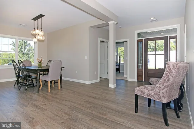 a view of a dining room with furniture window and wooden floor